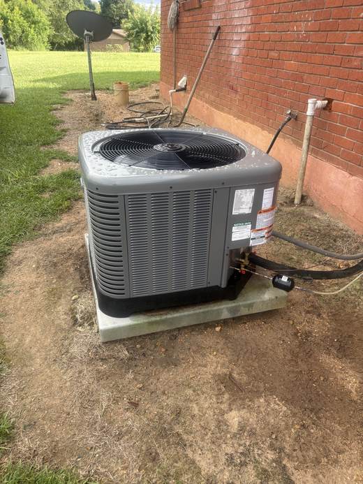 Rheem AC condenser unit installed on a brick home in Tylertown, MS