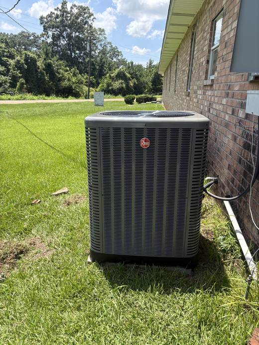 Rheem AC condenser installed beside a brick home in Tylertown, MS