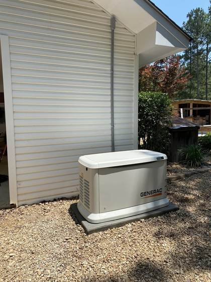 Generac standby generator installed beside a home