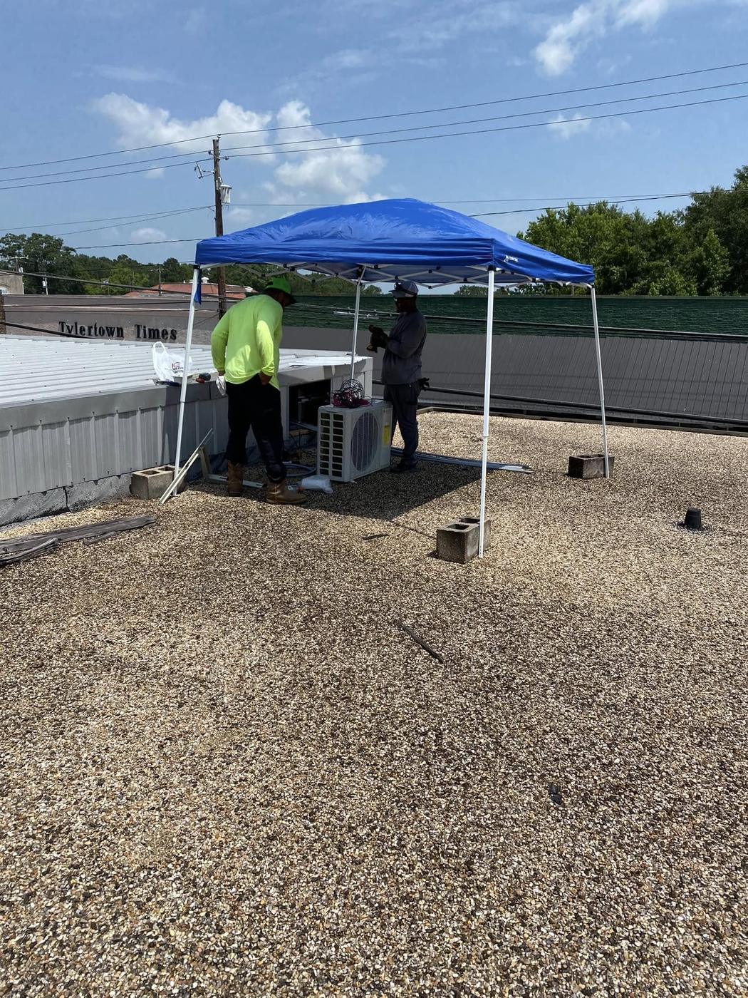 Jefferson's AC & Electrical technicians installing a commercial AC unit on a rooftop in Tylertown, MS